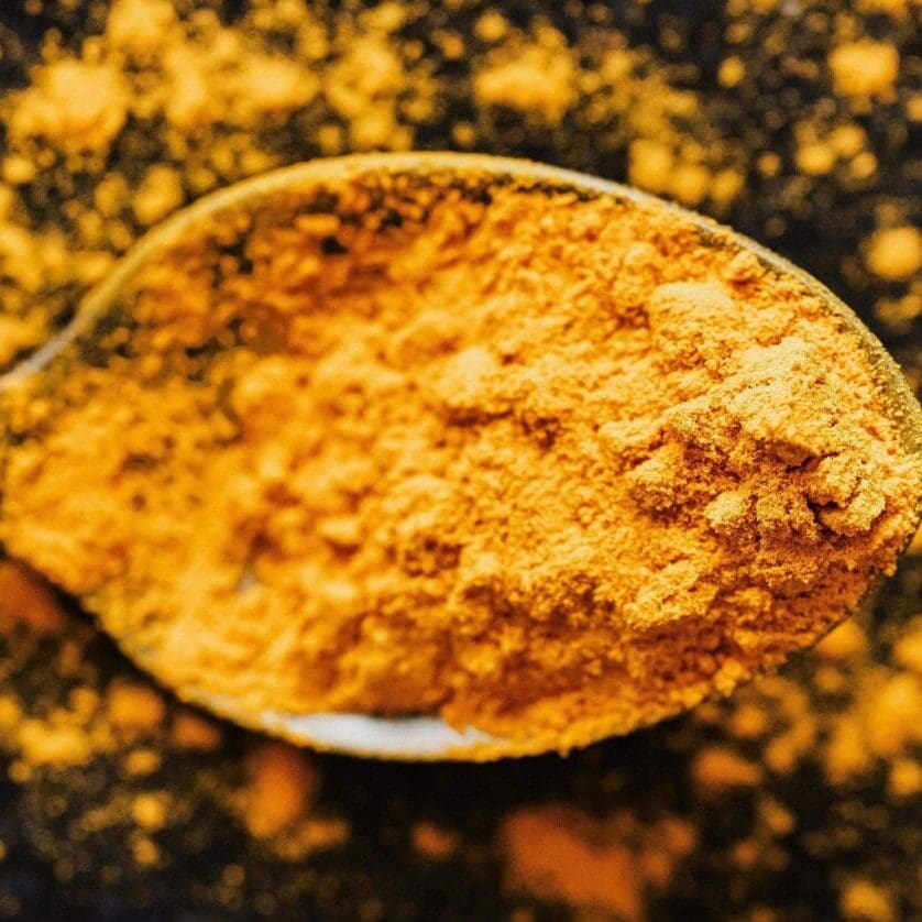 Close-up of turmeric powder on a spoon this link provides science and research to support the use of resveratrol and tumeric Get in the Rezzi Zone with organic resveratrol supplements for high performing men with turmeric